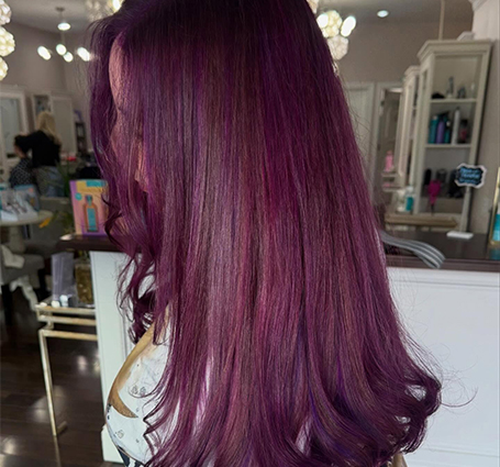 Back view of client showing long, voluminous hair extensions after styling