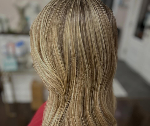 Client’s hair being blow-dried straight after keratin treatment application