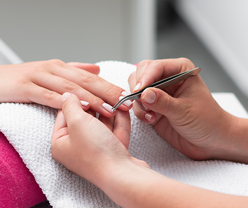 Display of colorful nail polish bottles arranged beside manicure tools