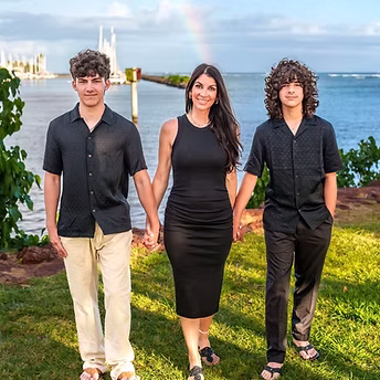 Close-up of stylist’s hands sectioning hair with comb and clips