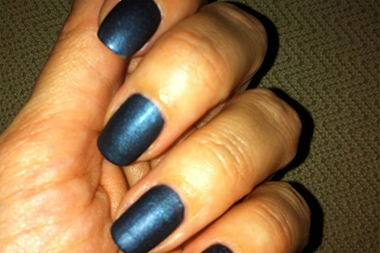 Organized product shelves showing professional haircare lines along salon wall