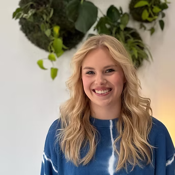 Wall display of professional hair products arranged on white shelving