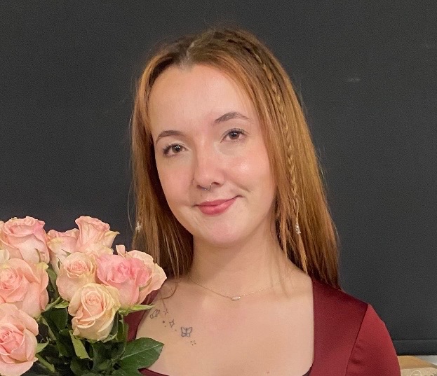 Group of stylists gathered around styling chair during in-salon training session