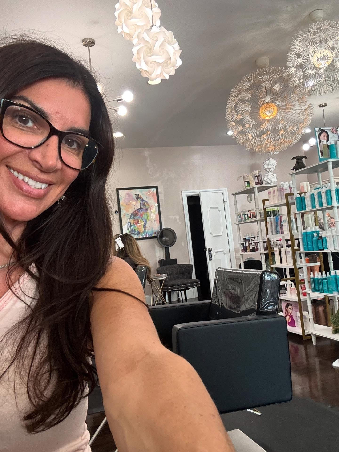 Stylist cutting a client’s hair in a modern Cincinnati salon